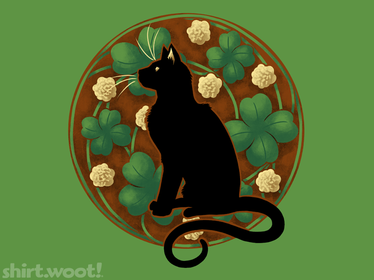 A black kitty sits tall in profile with a circlur Art Nouveau background of four leaf clovers, cream colored flowers on a brown background. The shirt is grass green.